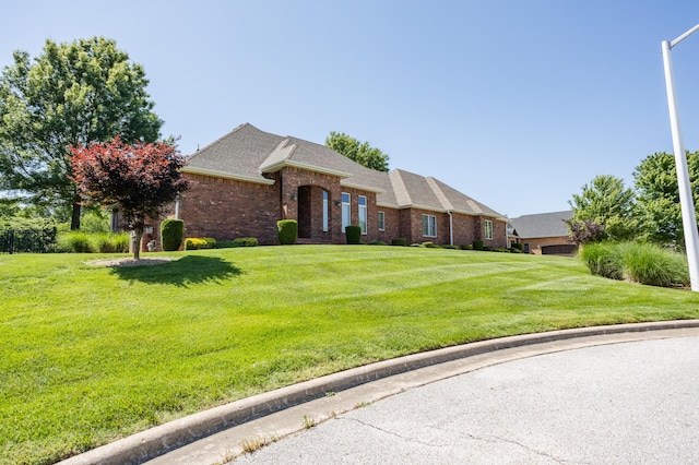 8326 Shinnecock Dr, Nixa, MO 65714 - view of front facade featuring brick siding, a front yard, and roof with shingles
