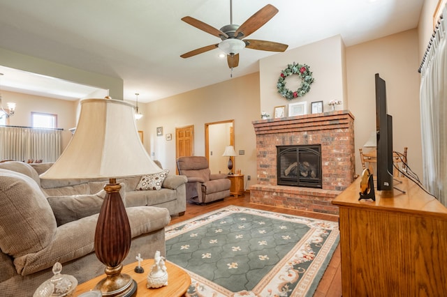 8326 Shinnecock Dr, Nixa, MO 65714 - living room featuring ceiling fan, a fireplace, and wood finished floors