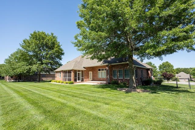 8326 Shinnecock Dr, Nixa, MO 65714 - rear view of house featuring a sunroom, brick siding, and a patio area