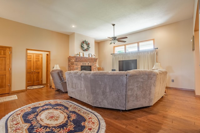 8326 Shinnecock Dr, Nixa, MO 65714 - living room featuring a fireplace, wood-type flooring, ceiling fan, baseboards, and recessed lighting