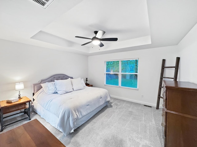 3824 N Spring Branch Ave, Springfield, MO 65803 - bedroom featuring a tray ceiling, baseboards, light carpet, and a ceiling fan