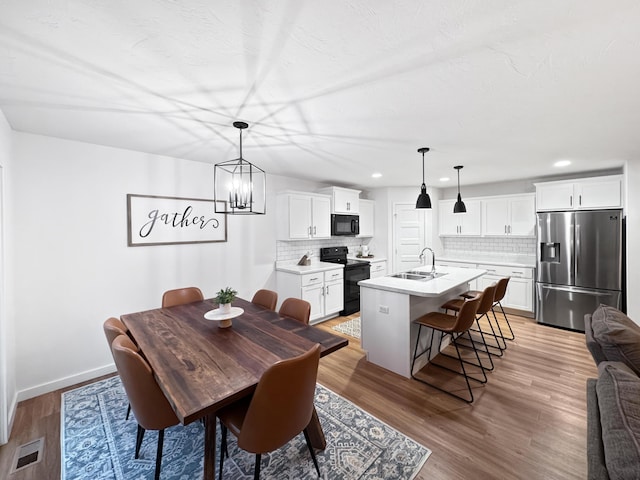 3824 N Spring Branch Ave, Springfield, MO 65803 - dining space with recessed lighting, baseboards, light wood-type flooring, and a chandelier