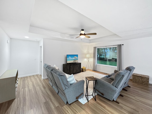 3824 N Spring Branch Ave, Springfield, MO 65803 - living room with a raised ceiling, light wood finished floors, baseboards, and a ceiling fan