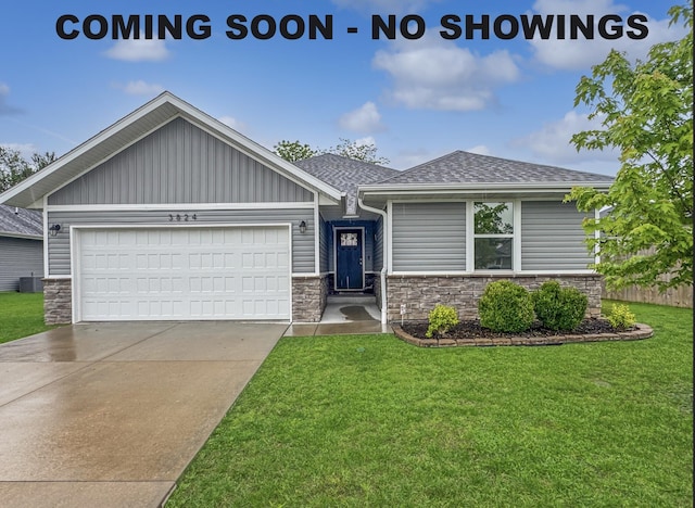 3824 N Spring Branch Ave, Springfield, MO 65803 - view of front of property featuring a front yard, stone siding, a shingled roof, and a garage