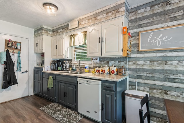 1127 E Livingston Ct, Springfield, MO 65803 - kitchen with white dishwasher, a sink, wooden walls, light countertops, and dark wood finished floors