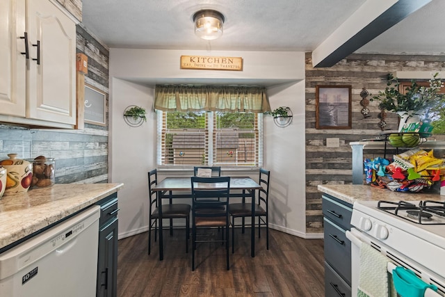1127 E Livingston Ct, Springfield, MO 65803 - kitchen with white appliances, dark wood-style flooring, light countertops, baseboards, and wooden walls