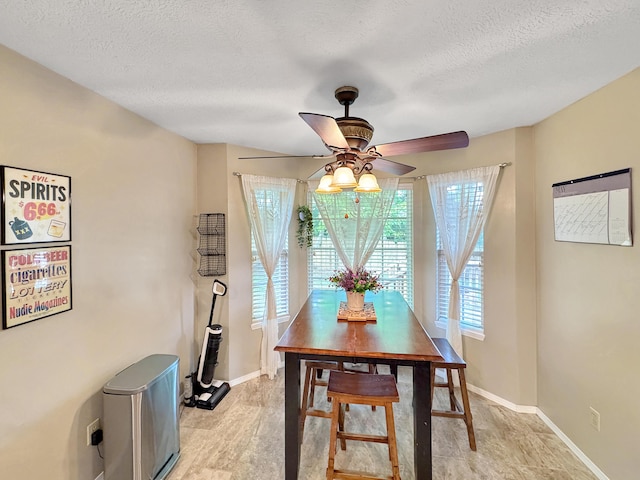 5726 S Fairview Ave, Springfield, MO 65810 - dining room featuring ceiling fan, a textured ceiling, and baseboards