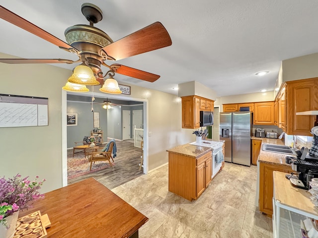 5726 S Fairview Ave, Springfield, MO 65810 - kitchen with appliances with stainless steel finishes, ceiling fan, a sink, light countertops, and brown cabinetry