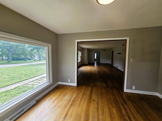 107 W Poplar St, El Dorado Springs, MO 64744 - unfurnished dining area with hardwood / wood-style flooring and baseboards