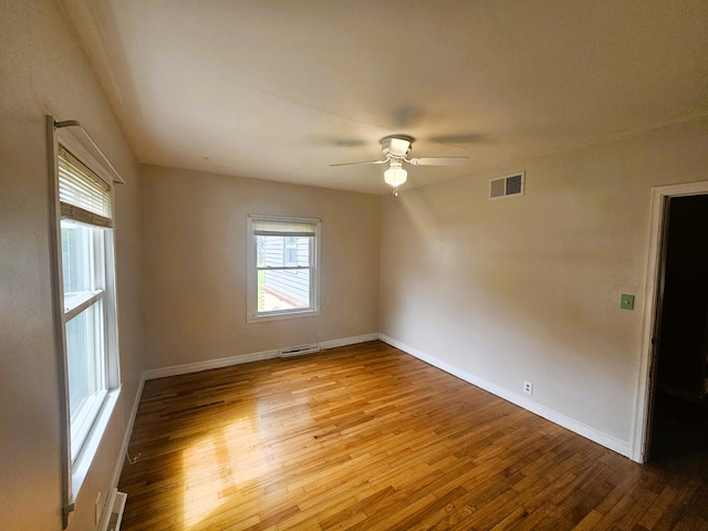 107 W Poplar St, El Dorado Springs, MO 64744 - spare room featuring a ceiling fan, wood finished floors, and baseboards