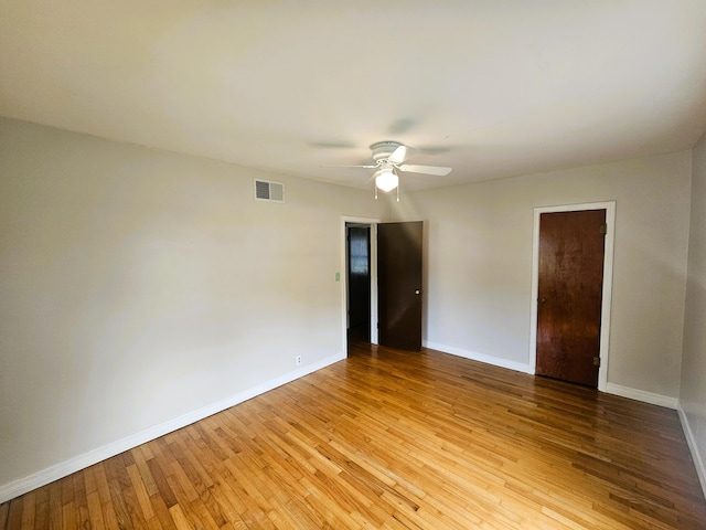 107 W Poplar St, El Dorado Springs, MO 64744 - spare room featuring a ceiling fan, light wood-style floors, and baseboards