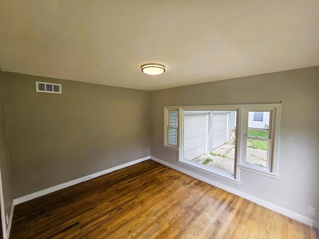 107 W Poplar St, El Dorado Springs, MO 64744 - spare room with baseboards and wood finished floors