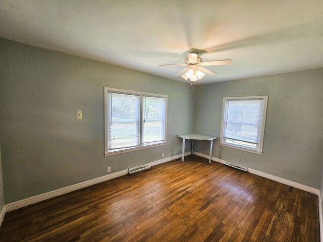 107 W Poplar St, El Dorado Springs, MO 64744 - spare room with hardwood / wood-style floors, a ceiling fan, and baseboards