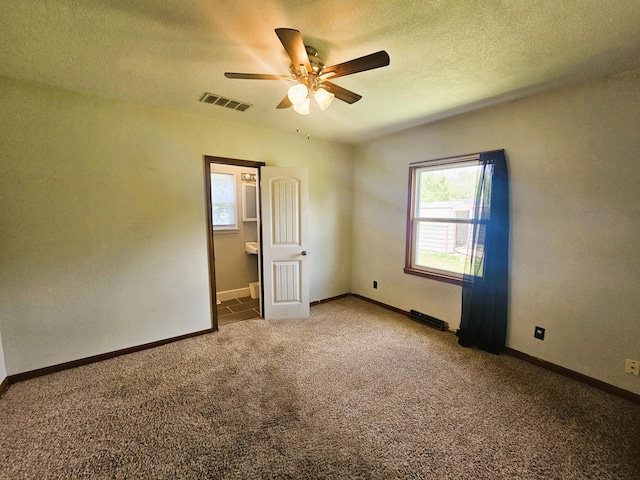 107 W Poplar St, El Dorado Springs, MO 64744 - unfurnished bedroom featuring carpet flooring, a textured ceiling, baseboards, and ceiling fan