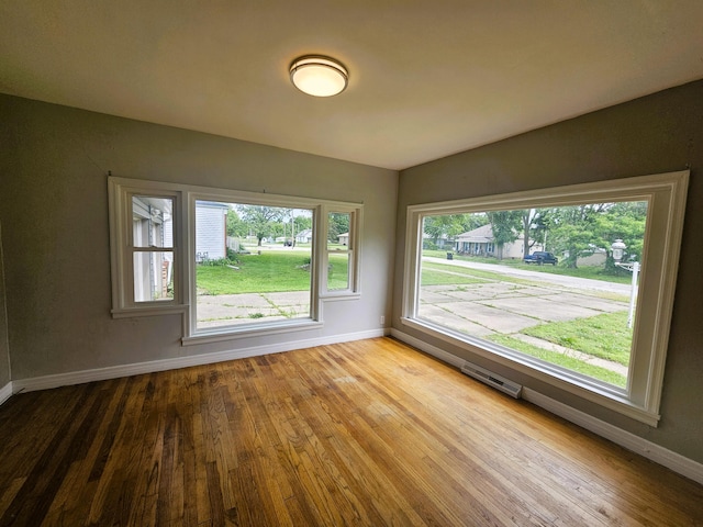 107 W Poplar St, El Dorado Springs, MO 64744 - spare room with baseboards and wood finished floors