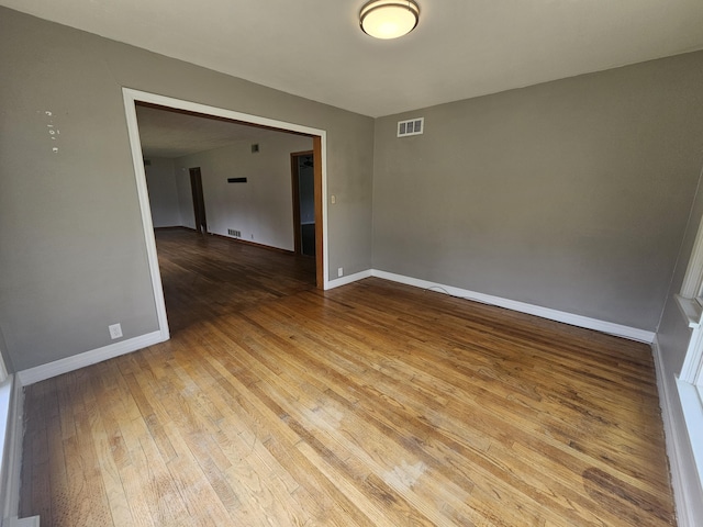 107 W Poplar St, El Dorado Springs, MO 64744 - spare room featuring hardwood / wood-style floors and baseboards