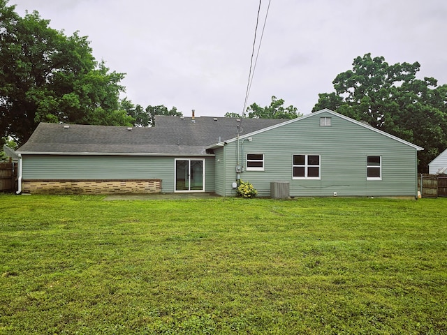 107 W Poplar St, El Dorado Springs, MO 64744 - back of house with central AC unit and a shingled roof