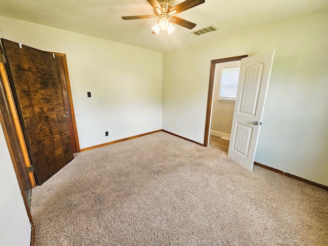 107 W Poplar St, El Dorado Springs, MO 64744 - unfurnished bedroom featuring carpet flooring, baseboards, and a ceiling fan