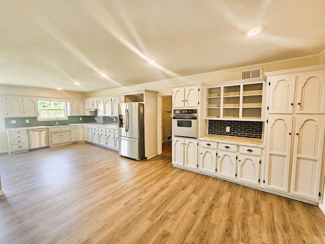 107 W Poplar St, El Dorado Springs, MO 64744 - kitchen with appliances with stainless steel finishes, open shelves, tasteful backsplash, light wood-style flooring, and recessed lighting