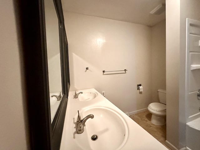 107 W Poplar St, El Dorado Springs, MO 64744 - bathroom with toilet, double vanity, and baseboards