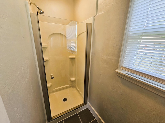 107 W Poplar St, El Dorado Springs, MO 64744 - bathroom featuring a stall shower and baseboards