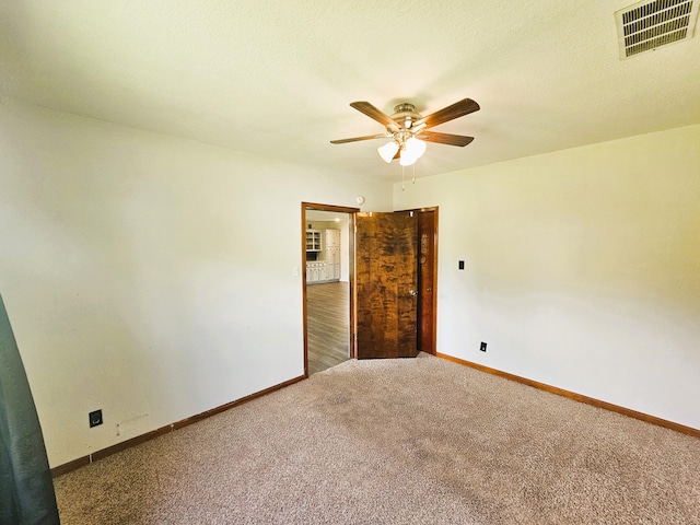 107 W Poplar St, El Dorado Springs, MO 64744 - unfurnished room featuring carpet flooring, ceiling fan, and baseboards