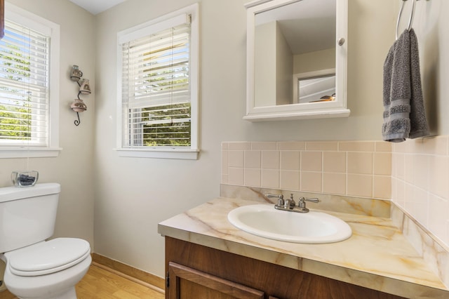 638 Double Day, Branson West, MO 65737 - bathroom with toilet, vanity, wood finished floors, backsplash, and baseboards