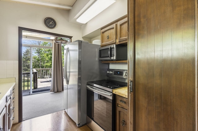 638 Double Day, Branson West, MO 65737 - kitchen with stainless steel appliances, light countertops, tasteful backsplash, and wood finished floors