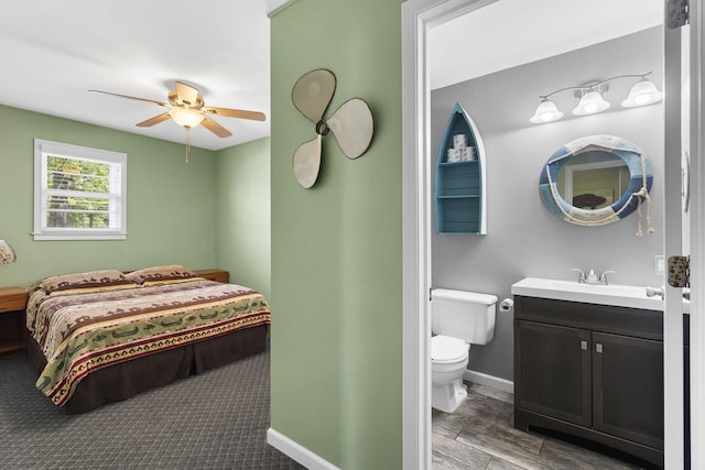 638 Double Day, Branson West, MO 65737 - bedroom with baseboards, ensuite bath, wood finished floors, ceiling fan, and a sink