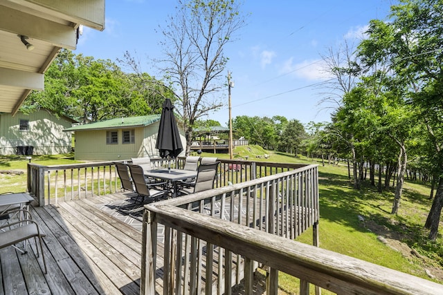 638 Double Day, Branson West, MO 65737 - wooden deck featuring outdoor dining area, a yard, and an outdoor structure