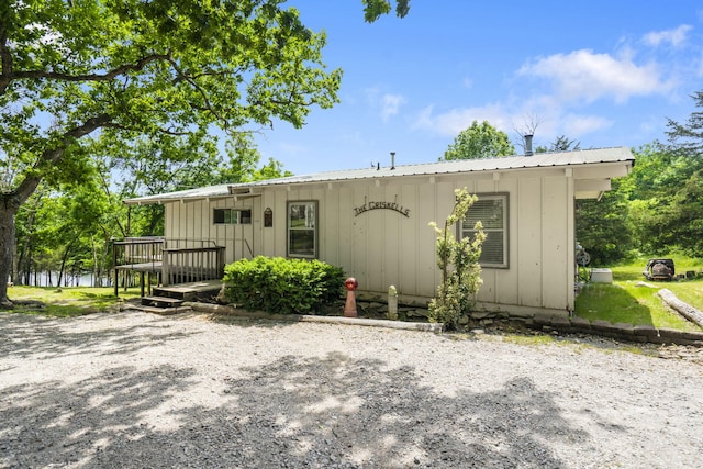 638 Double Day, Branson West, MO 65737 - view of front of house featuring board and batten siding, metal roof, and a deck