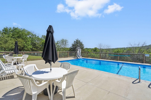638 Double Day, Branson West, MO 65737 - view of swimming pool with a water slide, outdoor dining area, and a patio