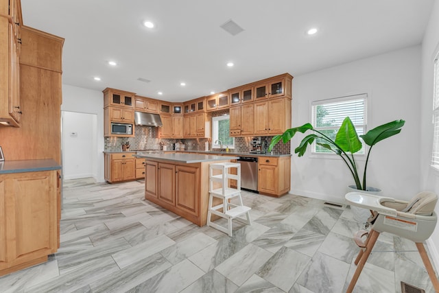 108 Island Green Dr, Republic, MO 65738 - kitchen featuring stainless steel appliances, under cabinet range hood, a breakfast bar, decorative backsplash, and a kitchen island