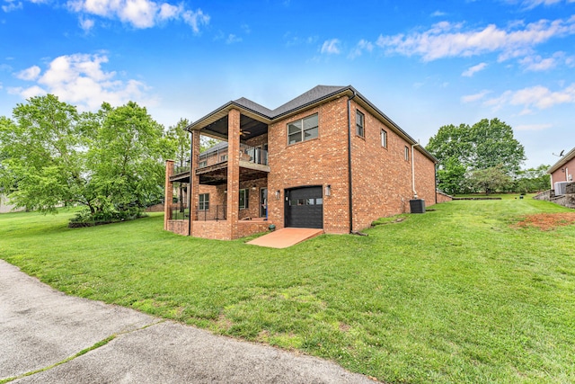 108 Island Green Dr, Republic, MO 65738 - rear view of house with brick siding, an attached garage, a yard, a balcony, and central AC unit
