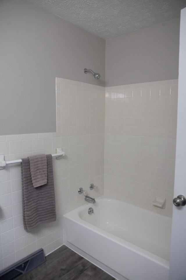 18627 Farm Rd Unit 1075, Exeter, MO 65647 - full bath featuring bathing tub / shower combination, wood finished floors, tile walls, and a textured ceiling