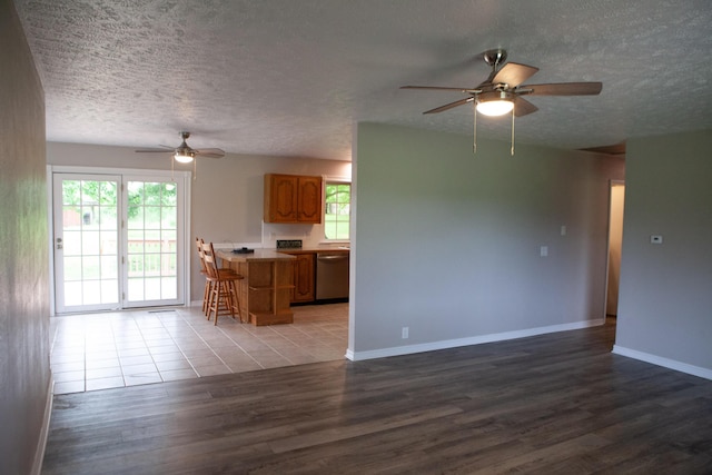 18627 Farm Rd Unit 1075, Exeter, MO 65647 - unfurnished living room with a ceiling fan, light wood-style flooring, a textured ceiling, and baseboards