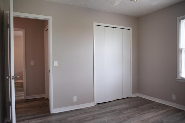 18627 Farm Rd Unit 1075, Exeter, MO 65647 - unfurnished bedroom with wood finished floors, a closet, baseboards, a ceiling fan, and multiple windows