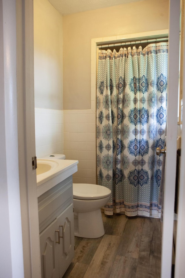 18627 Farm Rd Unit 1075, Exeter, MO 65647 - bathroom featuring tile walls, vanity, wood finished floors, wainscoting, and toilet