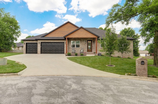 498 Mockingbird, Rogersville, MO 65742 - view of front of house featuring concrete driveway, a front yard, an attached garage, brick siding, and roof with shingles