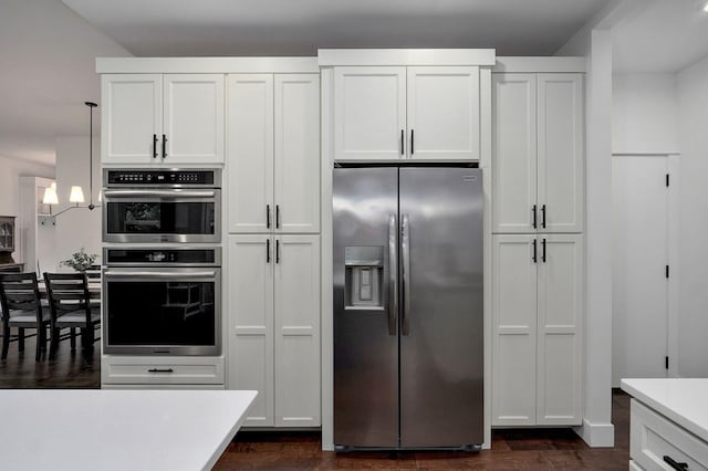 498 Mockingbird, Rogersville, MO 65742 - kitchen featuring stainless steel appliances, light countertops, dark wood finished floors, white cabinets, and hanging light fixtures