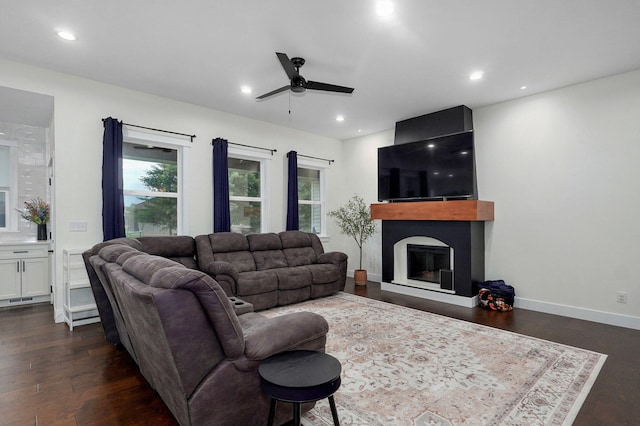 498 Mockingbird, Rogersville, MO 65742 - living room featuring ceiling fan, dark wood-style flooring, a glass covered fireplace, recessed lighting, and baseboards