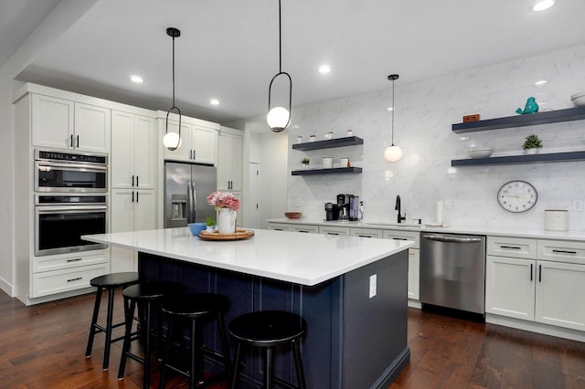 498 Mockingbird, Rogersville, MO 65742 - kitchen featuring stainless steel appliances, open shelves, tasteful backsplash, a sink, and a kitchen island