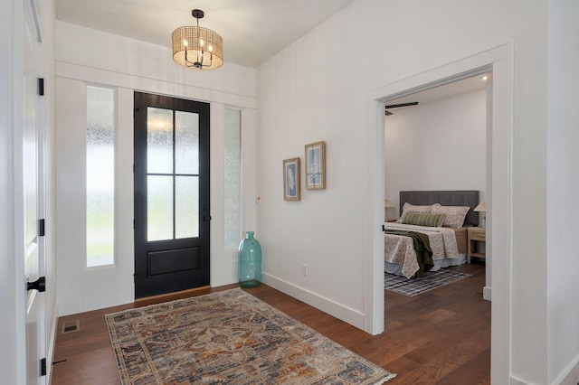 1756 N Marlowe Ave, Springfield, MO 65802 - foyer entrance with dark wood-style flooring, baseboards, and a chandelier