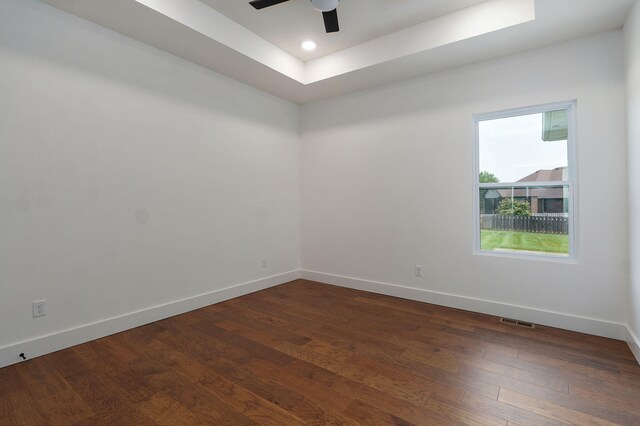 1756 N Marlowe Ave, Springfield, MO 65802 - spare room with baseboards, a tray ceiling, a ceiling fan, dark wood-style flooring, and recessed lighting