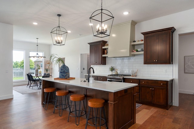 1756 N Marlowe Ave, Springfield, MO 65802 - kitchen with open shelves, gas stove, a chandelier, light countertops, and wood finished floors