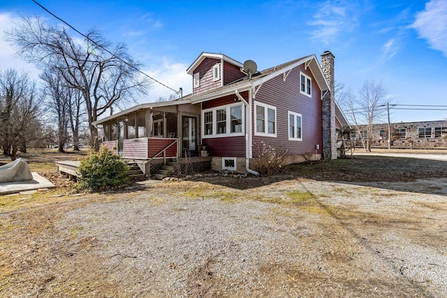 310 S Main St, Licking, MO 65542 - view of front of house featuring a sunroom and a chimney