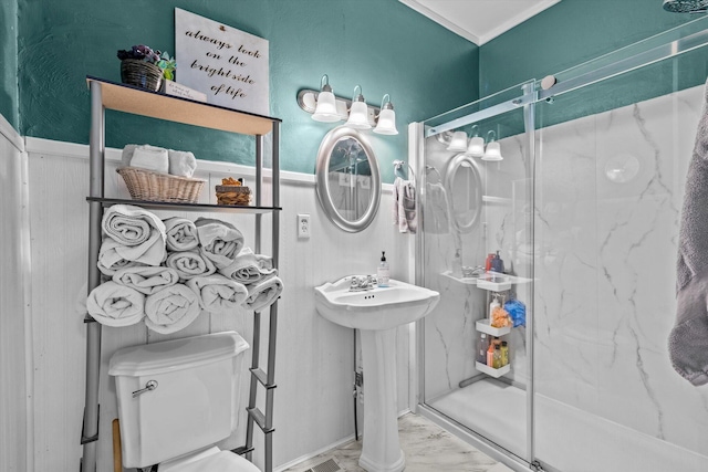 310 S Main St, Licking, MO 65542 - bathroom with marble look tile flooring, a marble finish shower, toilet, a wainscoted wall, and crown molding