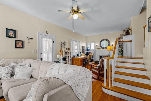 310 S Main St, Licking, MO 65542 - living area featuring ceiling fan, wood finished floors, stairway, and a fireplace