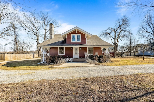 310 S Main St, Licking, MO 65542 - bungalow-style house with a chimney, covered porch, roof with shingles, and board and batten siding