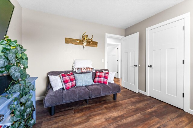 sitting room with wood finished floors and baseboards